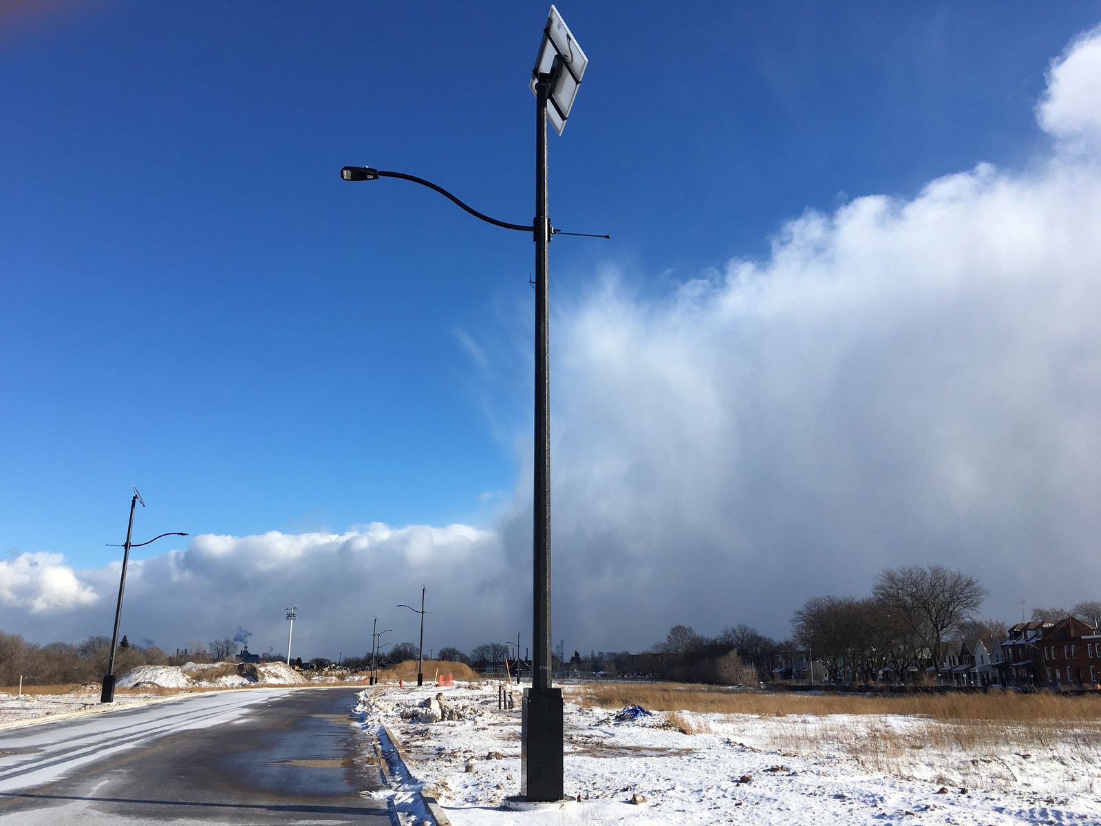 Cammi solar street lights lining a new subdivision road before the houses are built
